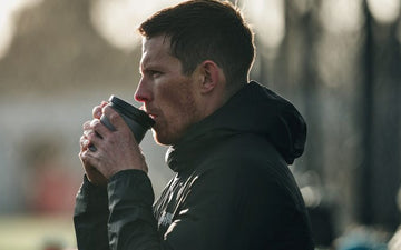 Athlete drinking coffee before training